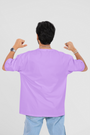 Back of the oversized lavender T-shirt features a striking graphic centered around the "Crazy Idea" theme, adding edge to a soft tone.

